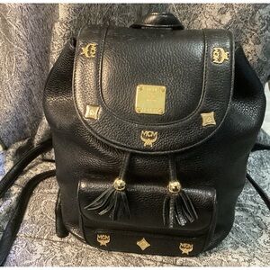 MCM black pebbled leather backpack with gold hardware and tassels